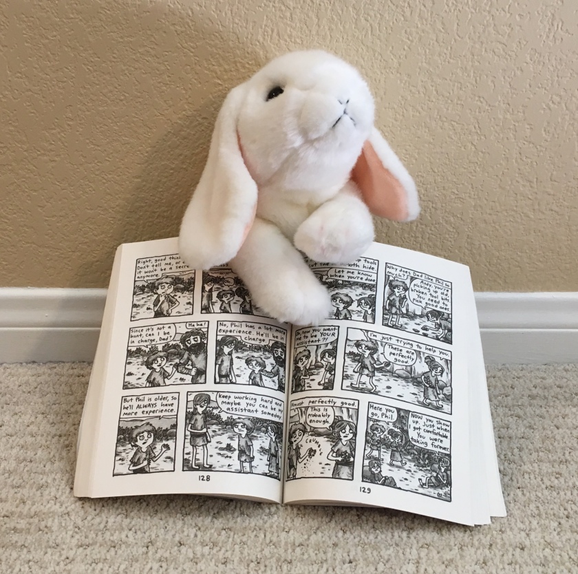 Marshmallow is pointing to a typical page of Lucy & Andy Neanderthal by Jeffrey Brown.  