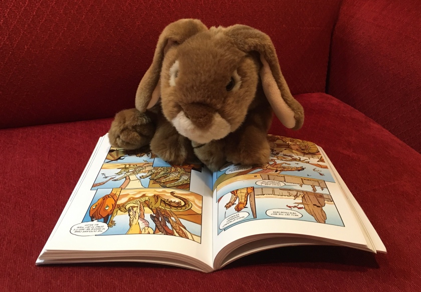 Caramel is reading The Brightest Night (the graphic novel version of Book Five of Wings of Fire) by Tui Sutherland and Mike Holmes.