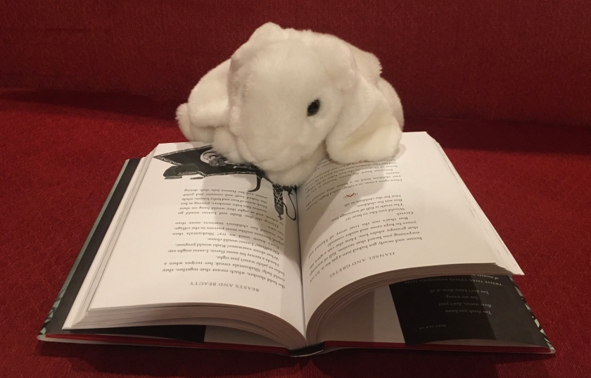 Marshmallow is reading Beasts and Beauty: Dangerous Tales by Soman Chainani.