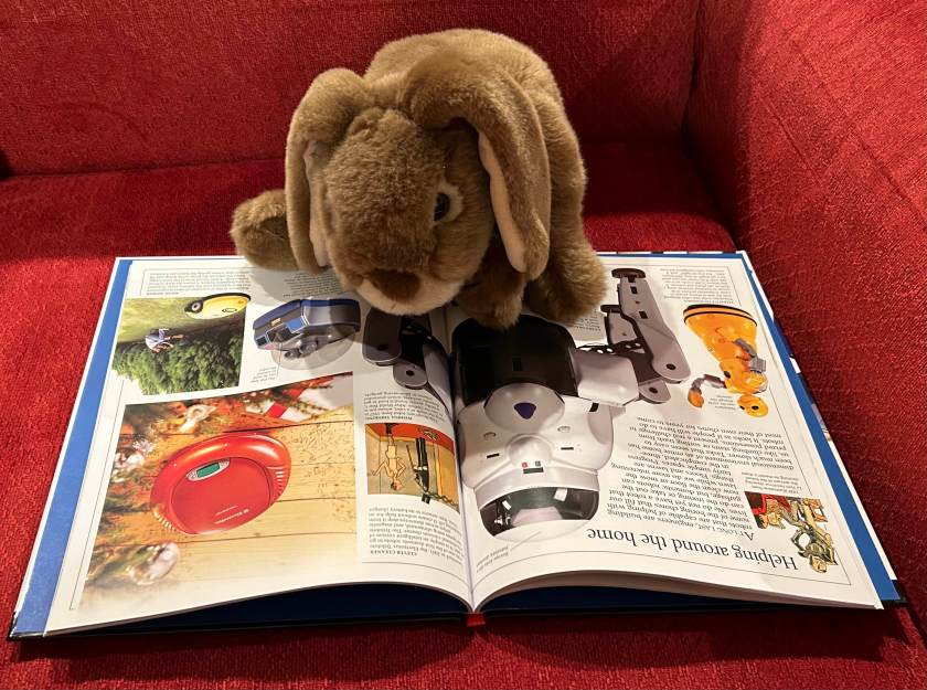 Caramel is reading Robot by Roger Bridgman and learning about robots that can help around the home.